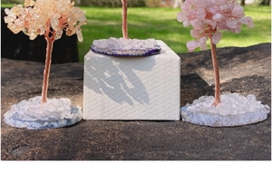 Detail of Citrine and Rose Quartz Tree of Life on agate base in outdoor setting