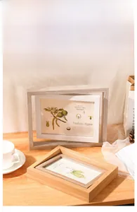 Close-up of a double-sided rotating wooden 5x7 photo frame with natural wood grain finish