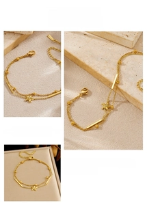 Detail of gold-plated stainless steel double-layered chain bracelet with starfish charm