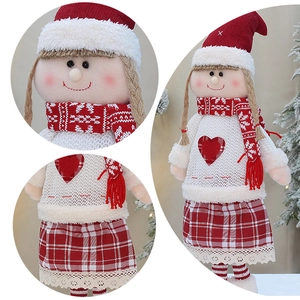 Close-up of knit Christmas girl doll featuring heart sweater and lace skirt details