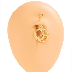 Golden snake-shaped belly button ring with sparkling rhinestones on model's skin