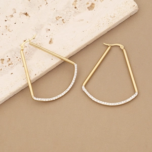 Detailed view of gold geometric trapezoid earrings with sparkling zircon micro-pave