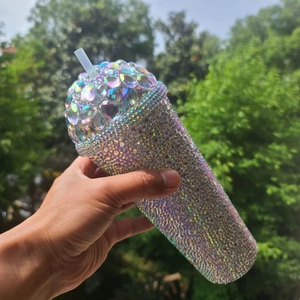 Detailed view of luxury rhinestone tumbler lid featuring heart-shaped gems and silver crystals
