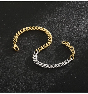 Detail of two-tone gold and silver Cuban link bracelet with lobster clasp on black background