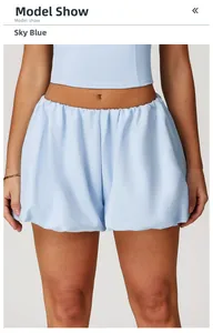 Detail of sky blue sports shorts with puff hem and elastic waist on model