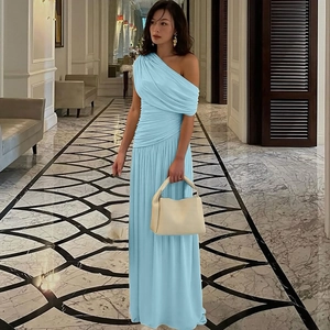 Detail of light blue one-shoulder maxi dress with elegant pleats and ruched fabric texture