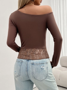 Detail view of the lace patchwork design on the back of this brown Y2K slim-fit knit top