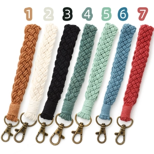 Detail showing seven colors of bohemian hand-woven cotton wristlet keychains with bronze clips