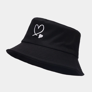 Detailed close-up of white heart embroidery on a black cotton canvas bucket hat