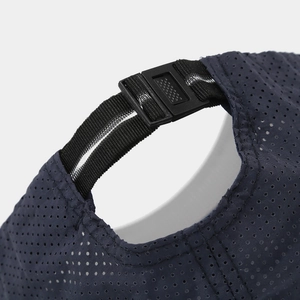 Detail of the navy blue mesh sports cap featuring an adjustable buckle strap and breathable fabric