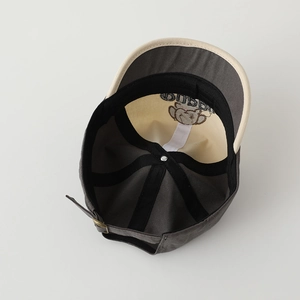 Detail view of cotton baseball cap with adjustable metal buckle and contrast color lining
