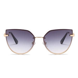 Women's cat eye sunglasses with purple gradient lenses and gold metal frame on white