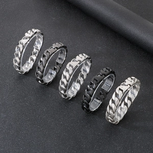 Detailed view of silver and black chain link rings arranged on a matte black background