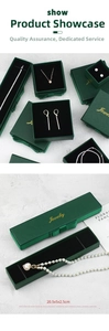 Close-up of dark green jewelry box featuring gold logo and luxury black velvet interior