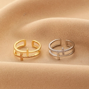 Macro shot of double-layer adjustable rings with cross element and paved zircon details