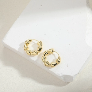 Minimalist 14K gold plated bamboo hoop earrings displayed on a white textured stone tray