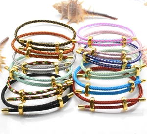 Detailed view of colorful braided steel wire ropes with golden metal figure-eight clasps