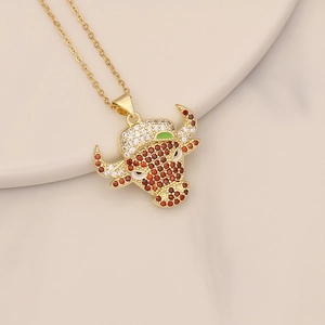 Macro shot of gold bull head pendant with colorful cubic zirconia stones and link chain