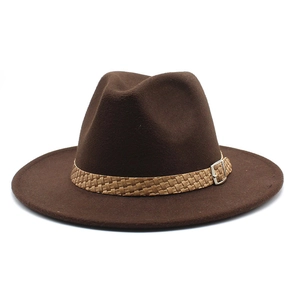 Detailed view of dark brown fedora hat with a woven band and silver buckle accent