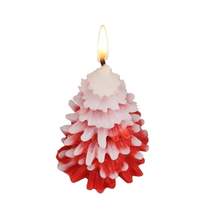 Christmas tree scented candle in red and white with snow effect on white background