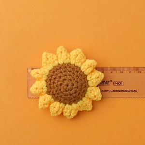 Handmade crochet sunflower pendant with yellow petals and brown center for DIY crafts