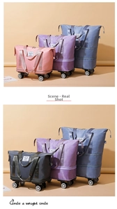 Close-up of four colorful waterproof travel bags showing universal wheels and smooth texture