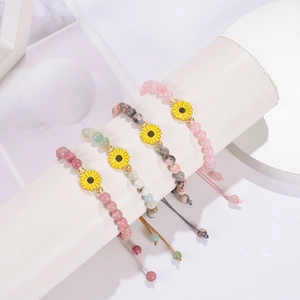 Detail of 6mm mahogany stone beaded bracelet with sunflower charm on white display