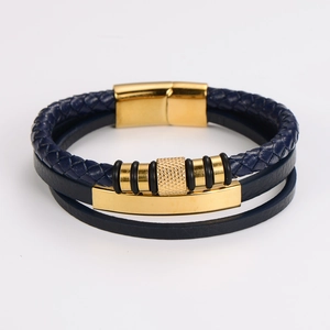 Detailed close-up of dark blue multilayer woven leather bracelet with gold magnetic clasp