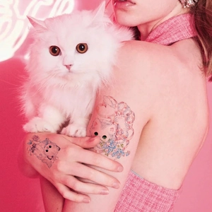 Y2K style colorful cat and flower temporary tattoos on a model in neon pink light