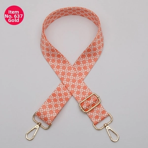 Close-up of bohemian orange floral bag strap with adjustable gold lobster buckles