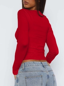 Vue arrière d'un haut rouge à manches longues ajusté avec un jean en denim bleu