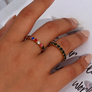 Close-up of gold plated rings with colorful micro-pave cubic zirconia on female fingers
