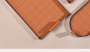 Detail of woven leather storage tray showing the textured orange surface and side handle