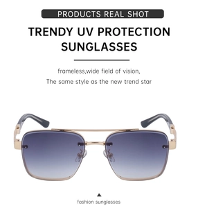 Detail of vintage square sunglasses with gold metal frame and blue gradient lenses