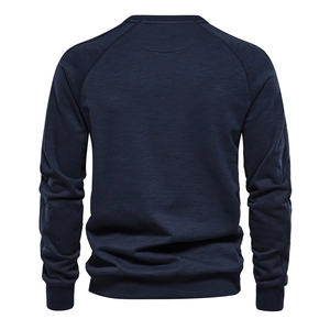 Detail of navy blue sweatshirt back showing raglan sleeves and rib-knit cuffs on white background