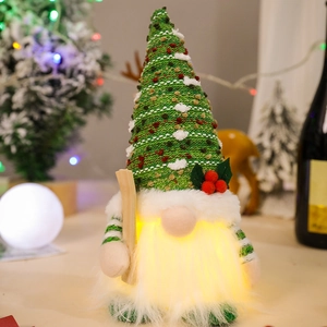 Glowing Christmas gnome plush with green knit hat, white beard and LED light decor