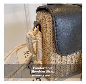 Detail of woven straw and black leather saddle bag with rope knot strap and gold hardware