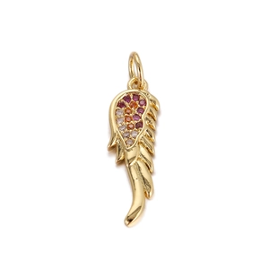 Macro shot of gold angel wing pendant with red and orange cubic zirconia stones