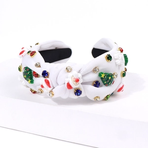 Close-up of white knotted headband with resin Santa, Christmas trees, and colorful rhinestones