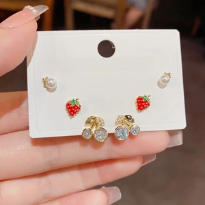 Detail of S925 silver studs set with enamel strawberry, cherry, and pearl designs