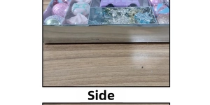 Side view of assorted Christmas ornaments including pink glitter balls and purple car toys
