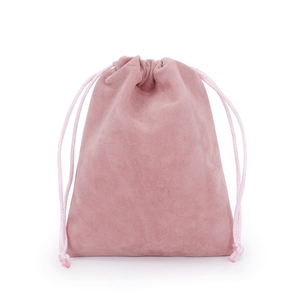 Detailed macro view of a pink velvet drawstring pouch with soft texture and woven cord