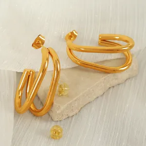 Elegant gold-plated multi-layer U-shaped oval stud earrings for women on stone background
