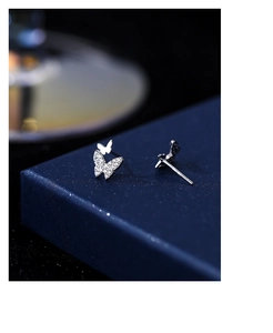 Detailed macro shot of sparkling S999 silver butterfly stud earrings with pavé crystals