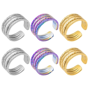Group of three-layer textured rings in silver, gold, and rainbow finish