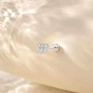 Macro view of 925 silver stud earring with three clear zircons and a flat back design