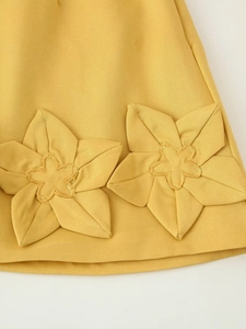 Gros plan détaillé du tissu sergé jaune avec des décorations de fleurs 3D faites main
