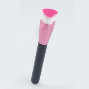 Macro shot of heart-shaped makeup brush with pink gradient bristles and metal ferrule