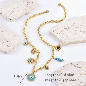 Detail of vintage gold necklace with evil eye, sun pendants and turquoise stone on stone