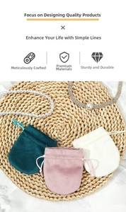 Macro detail of drawstring velvet jewelry pouches in green, pink and beige colors